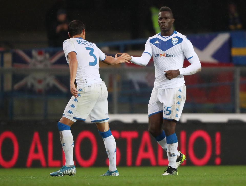 Brescia's Mario Balotelli, right, is congratulated by a teammate after scoring his side's first goal during the Italian Serie A soccer match between Verona and Brescia at the Bentegodi stadium in Verona, Italy, Sunday, Nov. 3, 2019. Verona supporters' racist chants upset the Italian bomber who also kicked the ball to fans in the standings. (Simone Venezia/ANSA via AP)