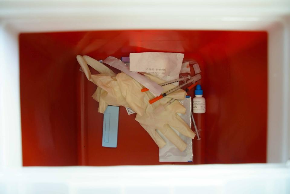 Old needles rest in a box for safe deposal on Brandywine Counseling's needle exchange van.