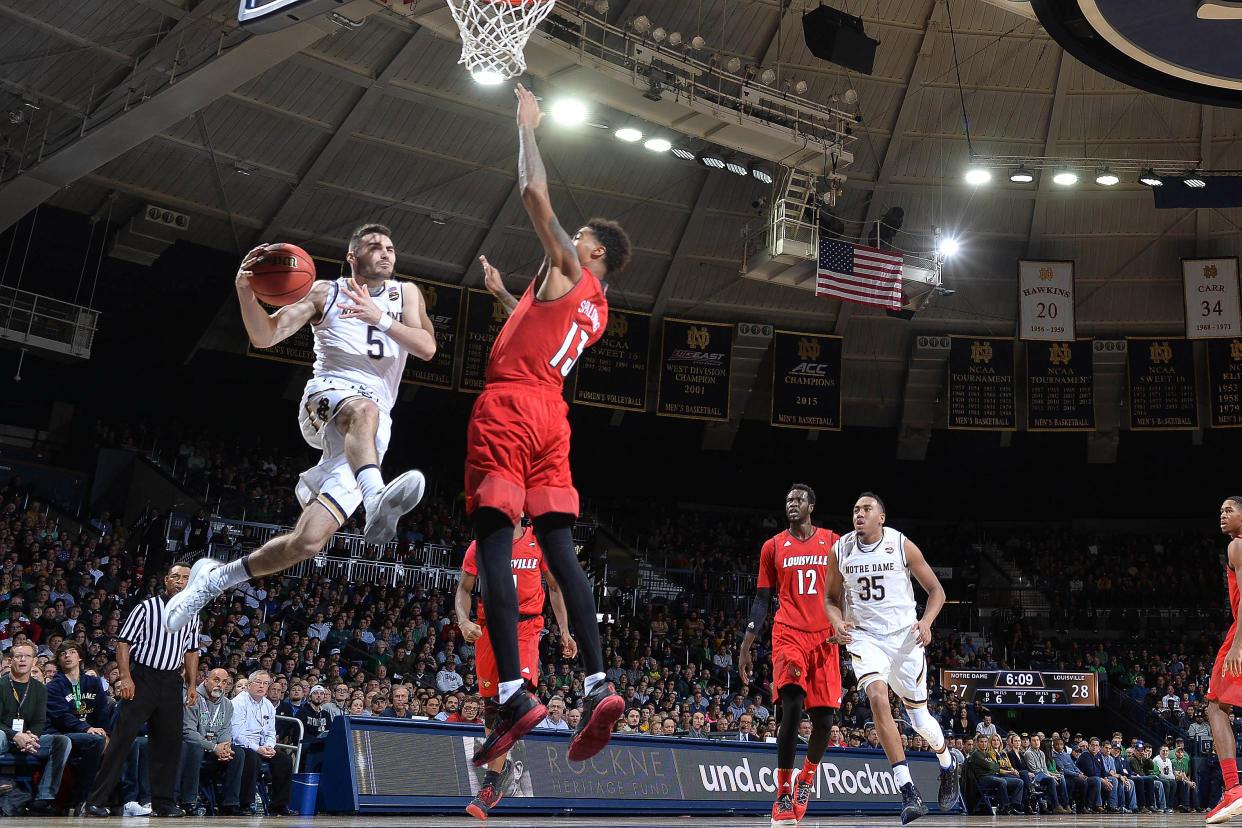 Jan 4, 2017; South Bend, IN, USA; Notre Dame Fighting Irish guard Matt Farrell (5) goes up for a shot as Louisville Cardinals forward Ray Spalding (13) defends in the first half at the Purcell Pavilion. Mandatory Credit: Matt Cashore-USA TODAY Sports