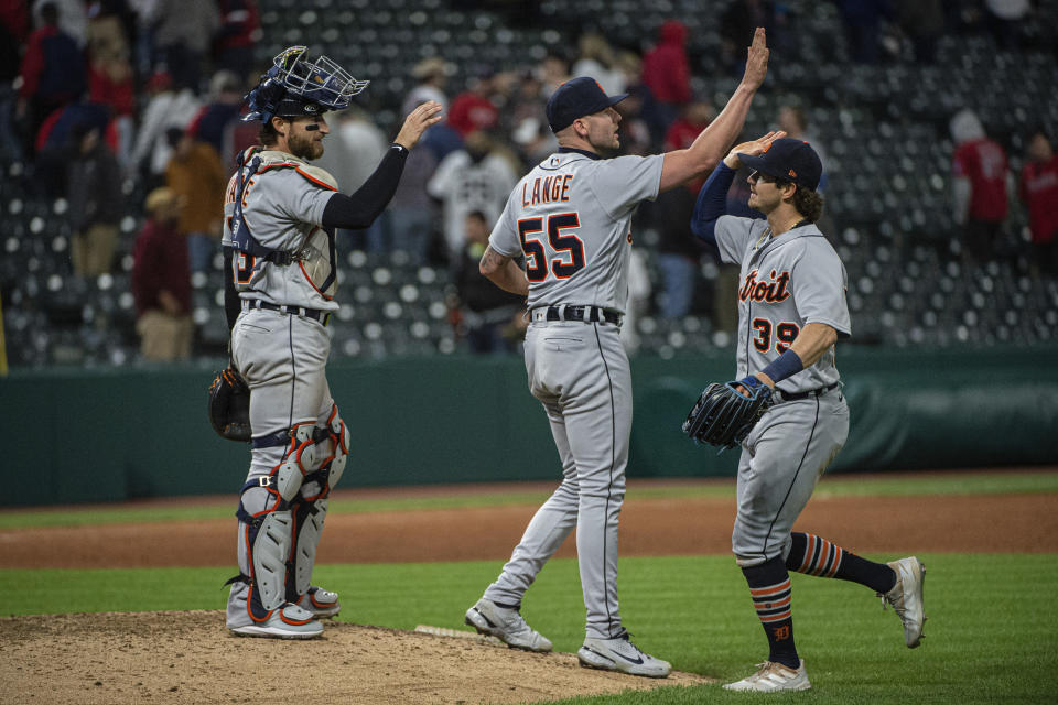 Detroit Tigers' catcher Eric Haase, left, and reliever Alex Lange (55) greet Zach McKinstry (39), right, after a win over the Cleveland Guardians in a baseball game in Cleveland, Monday, May 8, 2023. (AP Photo/Phil Long)