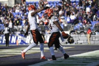 Cincinnati Bengals wide receiver Auden Tate, left, congratulates running back Samaje Perine after Perine scored on a long touchdown run against the Baltimore Ravens during the second half of an NFL football game, Sunday, Oct. 24, 2021, in Baltimore. (AP Photo/Nick Wass)