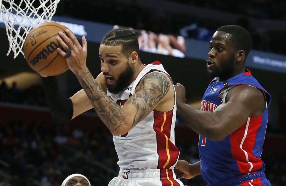 Miami Heat forward Caleb Martin (16) grabs a rebound in front of Detroit Pistons forward Eugene Omoruyi, right, during the first half of an NBA basketball game, Sunday, March 19, 2023, in Detroit. (AP Photo/Duane Burleson)