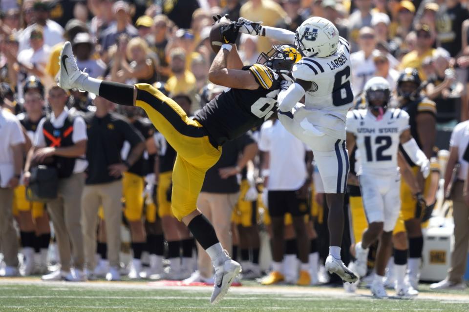 Iowa tight end Luke Lachey, left, catches a pass in front of Utah State safety Ike Larsen during the second half of an NCAA college football game, Saturday, Sept. 2, 2023, in Iowa City, Iowa. Iowa won 24-14. | Charlie Neibergall, AP