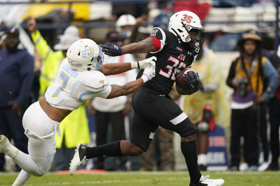 Jackson State running back Sy'veon Wilkerson breaks away from Southern University defensive back Jordan Carter (7) on his way to a 26-yard touchdown run during the second half of an NCAA college football game in Jackson, Miss., Saturday, Oct. 29, 2022. (AP Photo/Rogelio V. Solis)