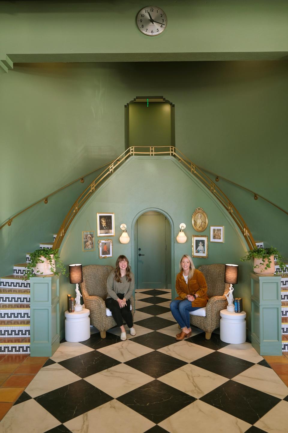 Molly Hall, left, and Elise Taylor sit by the original staircase inside The Harvey Bakery. A vintage Chrysler dealership in Midtown, 301 NW 13, has been transformed into a mix of offices, a workshop, bakery and cafe, Monday, November 22, 2021.