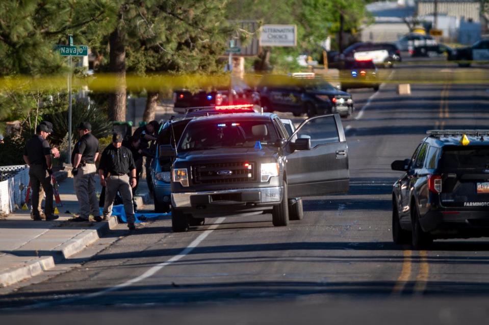 Law enforcement personnel investigate the scene of a shooting on North Dustin Avenue in Farmington, N.M., Monday. (ALBUQUERQUE JOURANL PUBLISHING COMPANY)