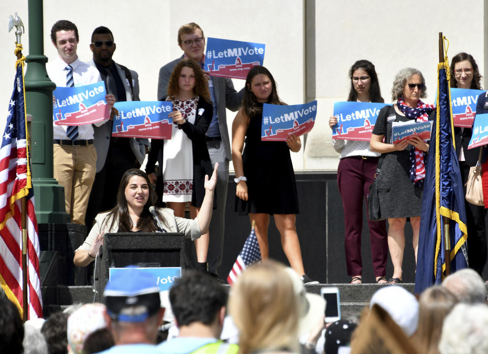 FILE - In this Wednesday, July 18, 2018 file photo, Katie Fahey talks to demonstrators as they rally outside the Michigan Hall of Justice in Lansing, Mich. Fresh off sweeping electoral victories a decade ago, governors and lawmakers in several states used new census data to redraw voting districts for Congress and state legislatures that were intended to help their party remain in power for years to come. Those efforts largely paid off, particularly for Republicans. An Associated Press analysis designed to detect the effects of gerrymandering shows that Republicans enjoyed a greater political advantage in more states over the past decade than either party had over the past 50 years. (Dale G. Young/Detroit News via AP, File)