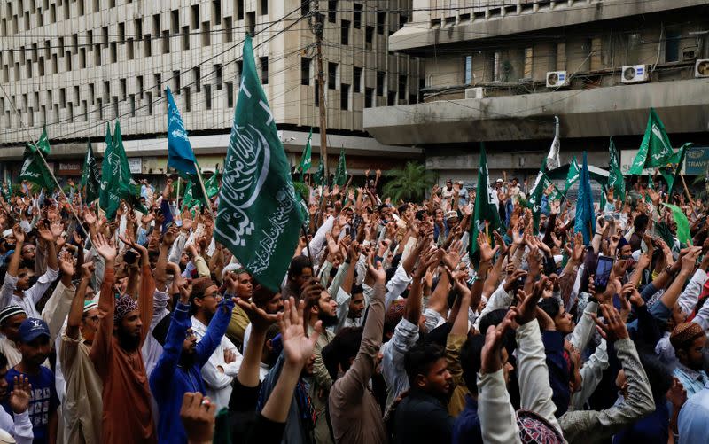 People chant slogans against the satirical French weekly newspaper Charlie Hebdo, which reprinted a cartoon of the Prophet Mohammad, during a protest in Karachi