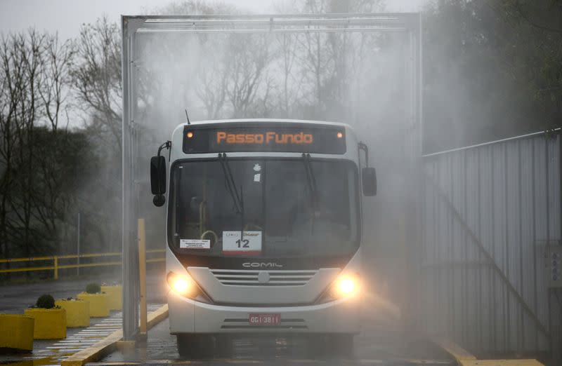 A bus used to transport employees at JBS SA's poultry factory goes through a disinfection tunnel after the company was hit by an outbreak of coronavirus disease (COVID-19) in Passo Fundo