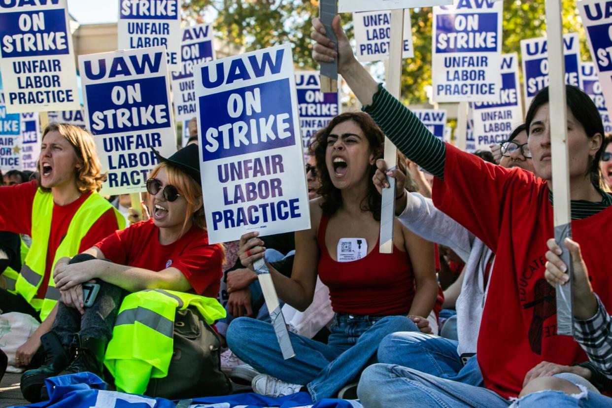 Demonstrators sit in while picketing at UC San Diego.