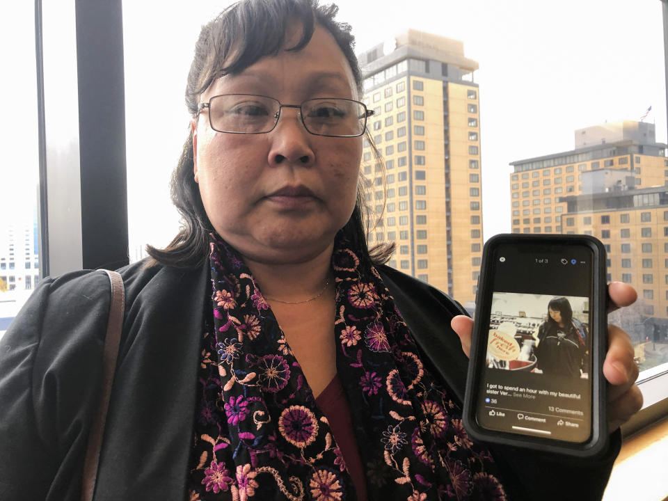 FILE - Rena Sapp, outside a courtroom Monday, Oct. 21, 2019, in Anchorage, Alaska, shows a photo of her sister, Veronica Abouchuk, taken during a day out shopping in 2013. Sapp attended the arraignment of Brian Steven Smith, who is accused of killing Abouchuk. (AP Photo/Mark Thiessen, File)