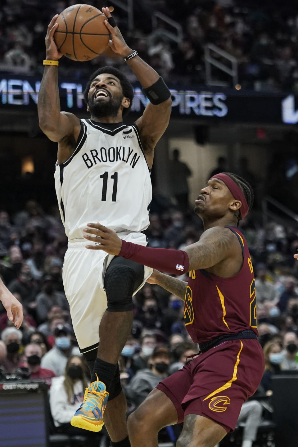 Brooklyn Nets' Kyrie Irving (11) drives against Cleveland Cavaliers' Brandon Goodwin (26) in the second half of an NBA basketball game, Monday, Jan. 17, 2022, in Cleveland. (AP Photo/Tony Dejak)