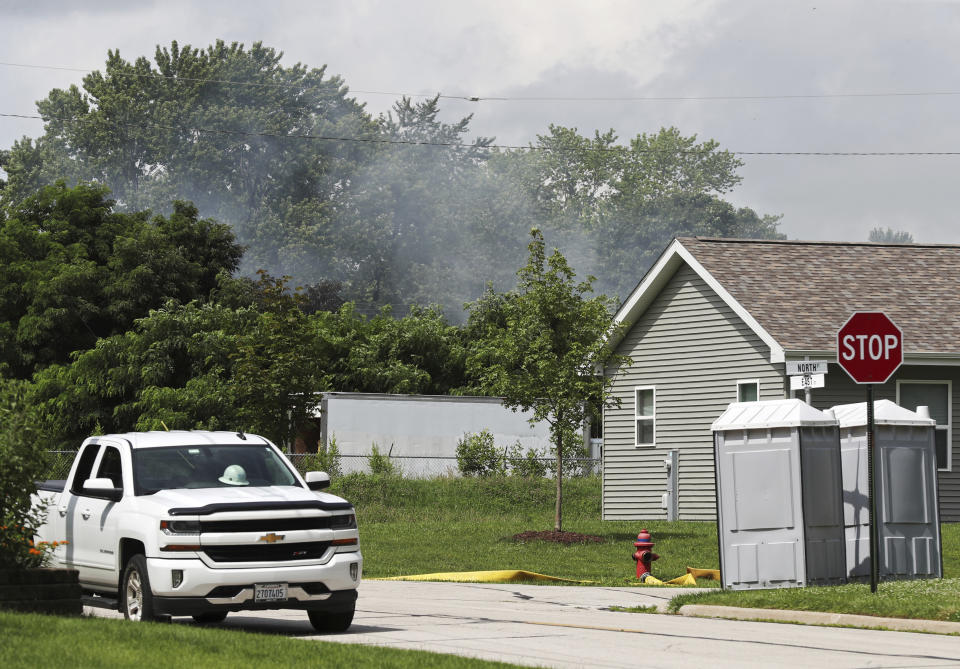 Smoke rises from the site of a burned building in the 900 block of East Benton Street Wednesday, June 30, 2021, in Morris, Ill. The building caught fire on Tuesday and contains lithium batteries, according to city officials. Area residents have been evacuated. (John J. Kim/Chicago Tribune via AP)