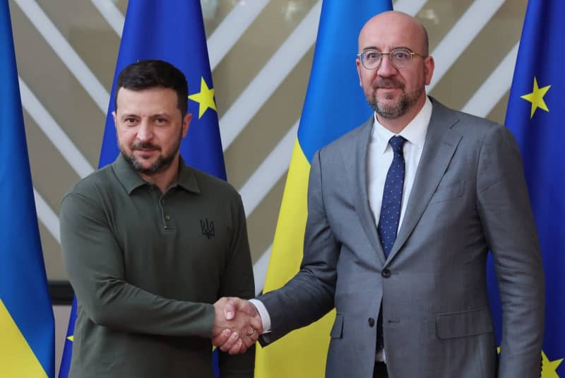 Ukraine's President Volodymyr Zelensky and European Council President Charles Michel shake hands on the first day of the European Council summit in Brussels.  Benoit Doppagne/Belga/dpa