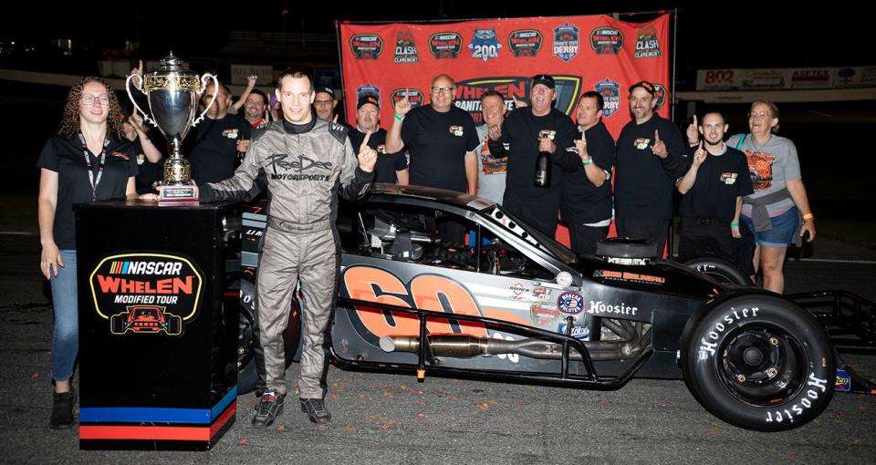 Matt Hirschman, driver of #60 PeeDee Motorsports Modified car, poses for a photo with the pit crew after winning the inaugural Whelen Granite State Short Track Cup championship, during the Clash at Claremont 150 for the Whelen Modified Tour at Claremont Motorsports Park on July 29, 2022 in Claremont, New Hampshire. (Rachel O\