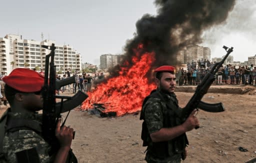 Members of Hamas's security forces in Gaza City on October 22, 2018, as confiscated drugs are set ablaze