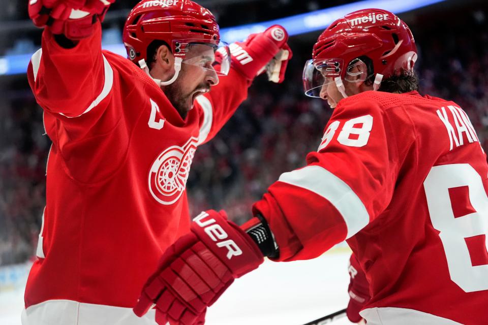 Detroit Red Wings right wing Patrick Kane, right, celebrates his goal against the Colorado Avalanche with Dylan Larkin, left, during overtime at Little Caesars Arena in Detroit on Thursday, Feb. 22, 2024.