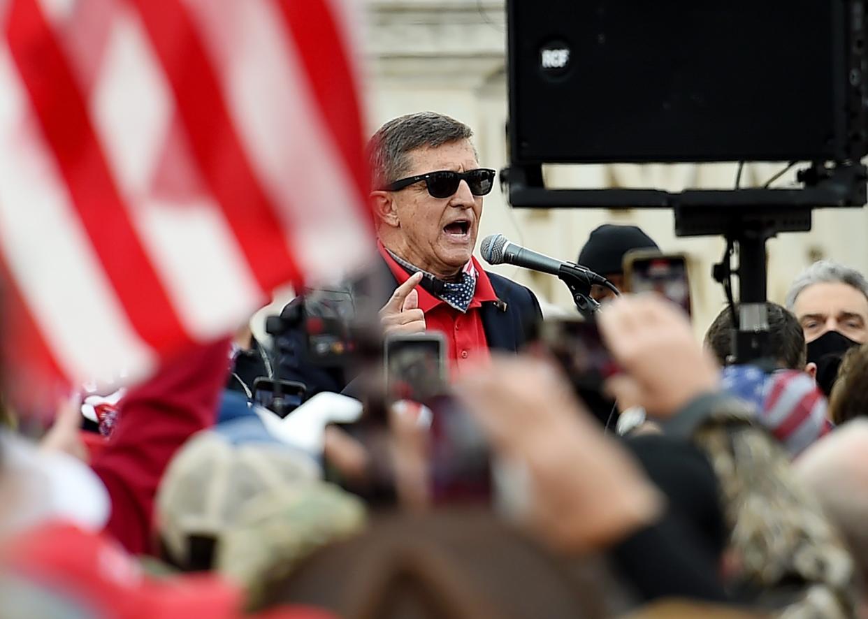 <p>Former US National Security Advisor Michael Flynn speaks to supporters of US President Donald Trump during the Million MAGA March to protest the outcome of the 2020 presidential election in front of the US Supreme Court on December 12, 2020 in Washington, DC</p> (AFP via Getty Images)