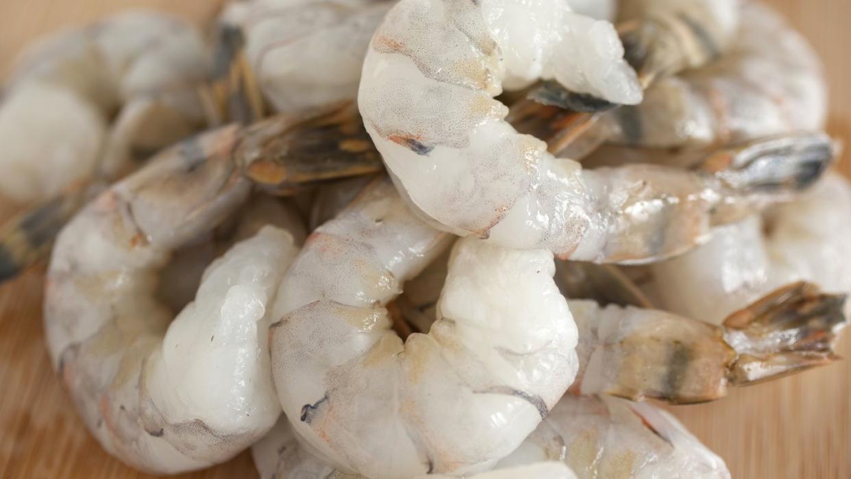 pile of shrimp on a wooden countertop