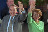 FILE - Republican presidential nominee Bob Dole and his wife Elizabeth wave to well-wishers at a rally in downtown Phoenix, Oct. 25, 1996. Bob Dole, who overcame disabling war wounds to become a sharp-tongued Senate leader from Kansas, a Republican presidential candidate and then a symbol and celebrant of his dwindling generation of World War II veterans, has died. He was 98. His wife, Elizabeth Dole, posted the announcement Sunday, Dec. 5, 2021, on Twitter. AP Photo/Scott Troyanos, File)