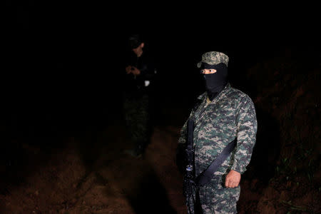 A Honduras soldier guards the area where Hilda Hernandez, the sister of Honduran President Juan Orlando Hernandez, and five others died when the helicopter they were traveling in crashed in San Matias, Honduras December 16, 2017. REUTERS/ Jorge Cabrera