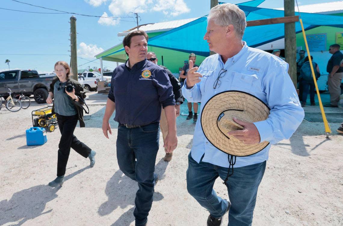 Robin Pearl, right, owner of Sun Shrimp on Pine Island, speaks with Gov. Ron DeSantis, who visited the island after Hurricane Ian on Tuesday, Oct. 4, 2022.