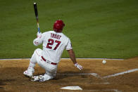 Los Angeles Angels' Mike Trout tumbles after he was hit by a foul ball during the seventh inning of a baseball game against the Los Angeles Dodgers, Friday, Aug. 14, 2020, in Anaheim, Calif. (AP Photo/Jae C. Hong)