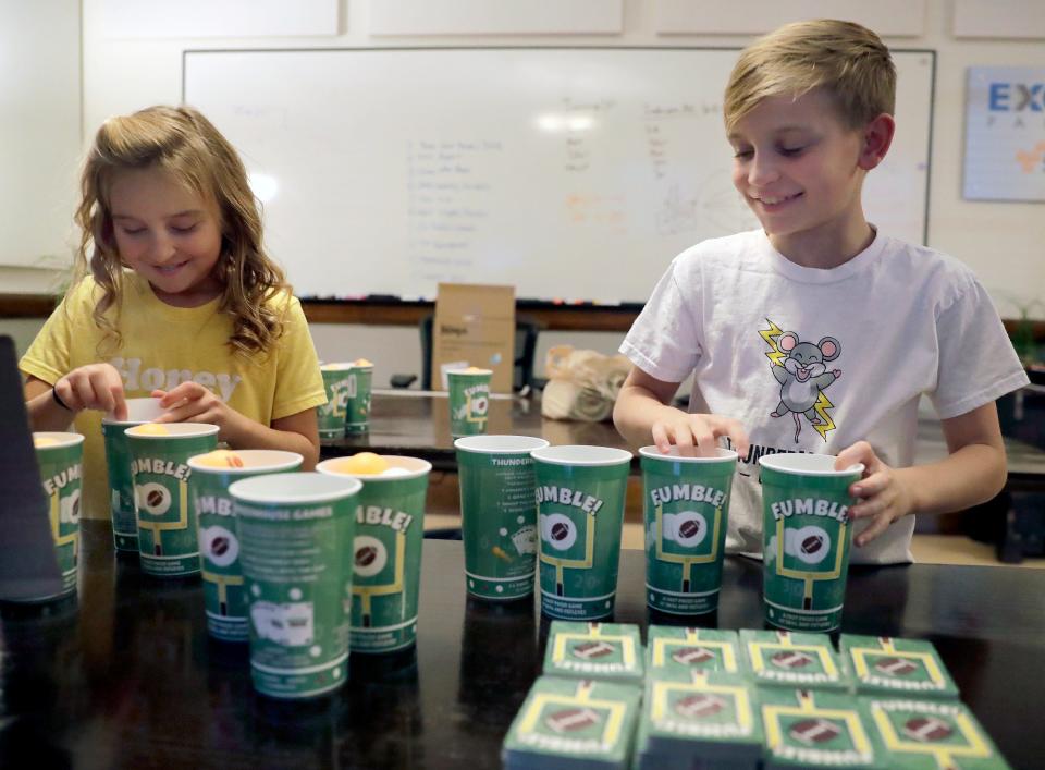 Brother and sister Daphne and Nolan Moore assemble a game they invented called FUMBLE! The siblings, through their company ThunderMouse Games, are selling Fumble! on Amazon.