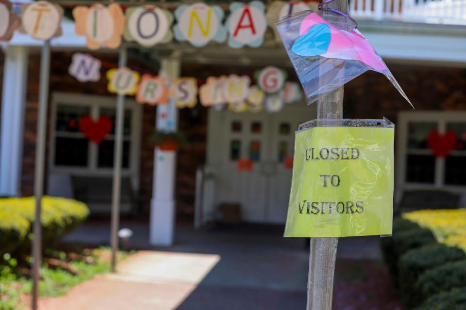 A sign posted near the entrance to the Kimberly Hall South nursing home shows the home closed to visitors, Thursday, May 14, 2020 in Windsor, Conn.