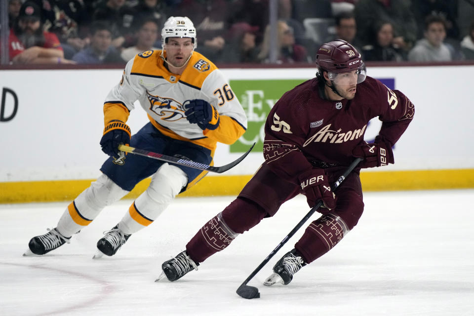 Arizona Coyotes defenseman Sean Durzi skates away from Nashville Predators left wing Cole Smith (36) during the second period of an NHL hockey game Thursday, March 28, 2024, in Tempe, Ariz. (AP Photo/Rick Scuteri)