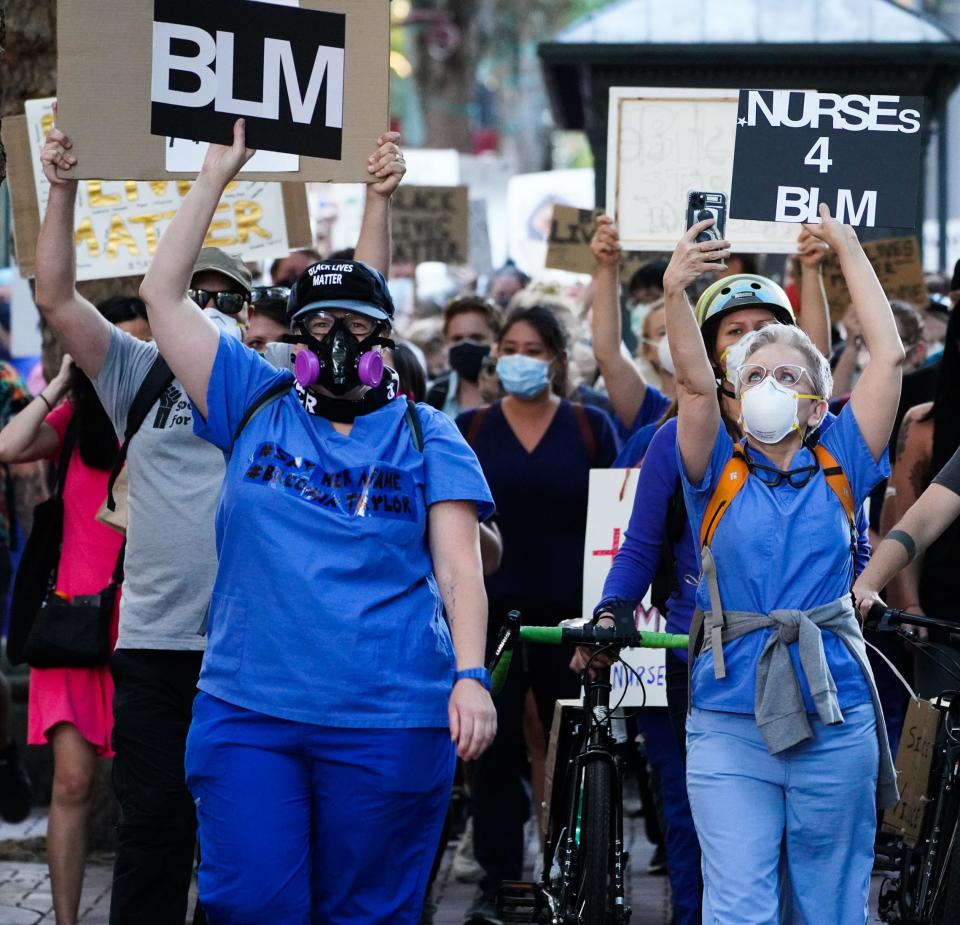 ER nurses Beth Higginbotham, 54, right, and Melanie Hamlin, 45, lead a march for Black Lives Matter in Portland, Oregon, on July 25, 2020.