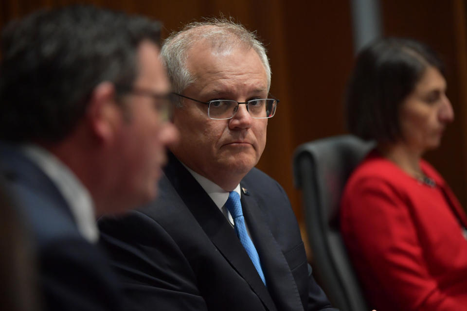 CANBERRA, AUSTRALIA - DECEMBER 11: Australian Prime Minister Scott Morrison (centre) together with Premier of Victoria Daniel Andrews (left) and Premier of New South Wales Gladys Berejiklian (right) address the media in the Main Committee Room at Parliament House, on December 11, 2020 in Canberra, Australia. Australia's leaders are meeting face to face for the first time in nine months, after Prime Minister Scott Morrison convened 32 virtual meetings of the National Cabinet with premiers and chief ministers since March to coordinate responses to COVID-19. (Photo by Sam Mooy/Getty Images)