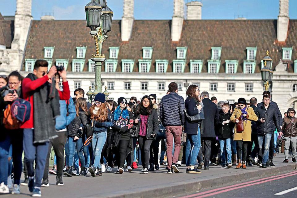 Business as usual: commuters and tourists make their way across Westminster Bridge today, so soon after the terrorist attack: Getty Images