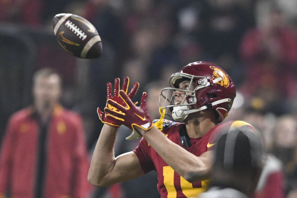 Southern California wide receiver Duce Robinson (19) makes a touchdown catch against Louisville during the second half of the Holiday Bowl NCAA college football game Wednesday, Dec. 27, 2023, in San Diego. (AP Photo/Denis Poroy)