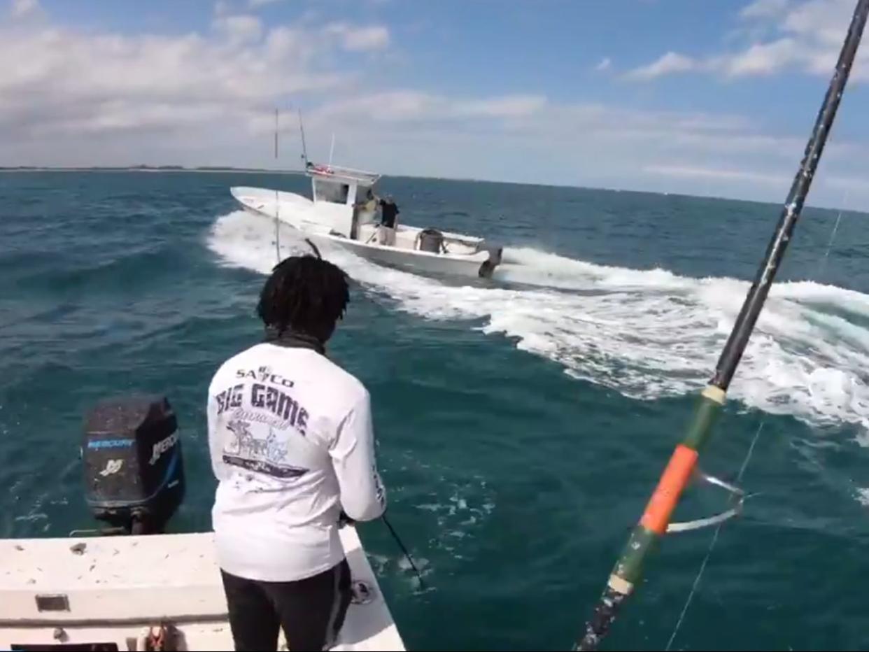 <p>Video shows a Black fisherman verbally abused by men aboard another boat</p> (Sharkinwithseaweed / YouTube)