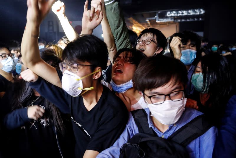 Fans wearing protective masks enjoy a band's performance at Hidden Agenda: This Town Needs (TNN) Live House during the club's last concert as business plummets due to the fear of the coronavirus, in Hong Kong