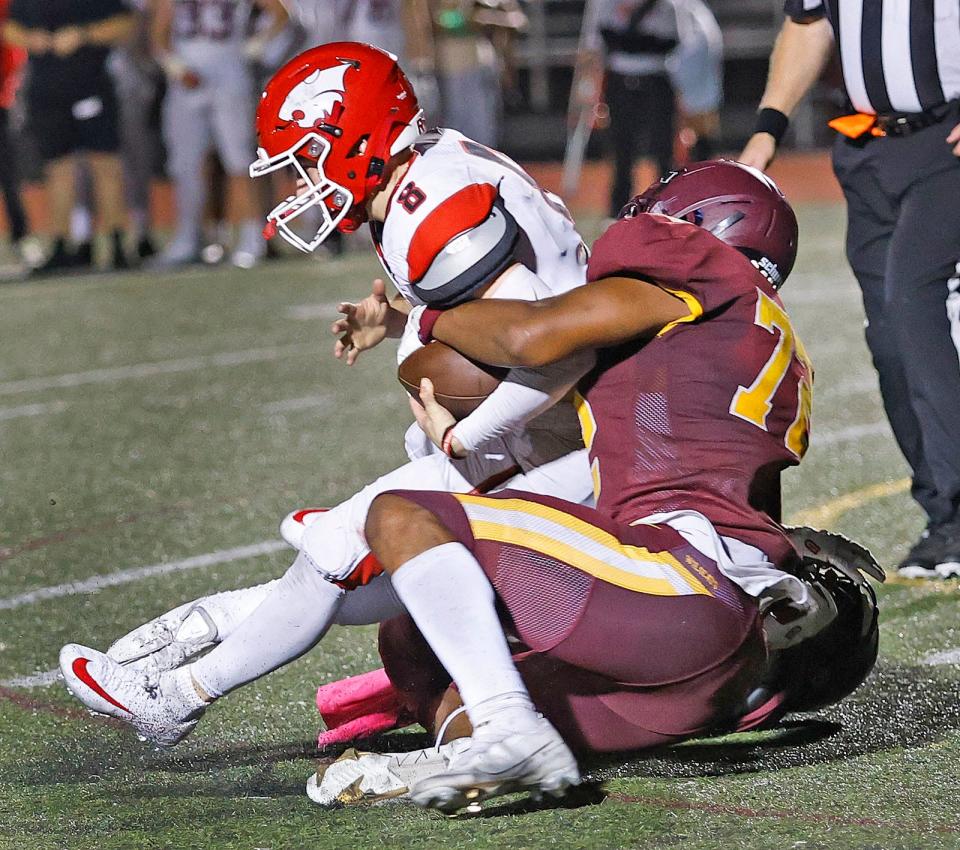 Weymouth lineman Naheem Ridore sacks Milton QB Patrick Collins for a loss.

The Weymouth Wildcats hosted the Milton Wildcats on the gridiron on Friday, October 4, 2024