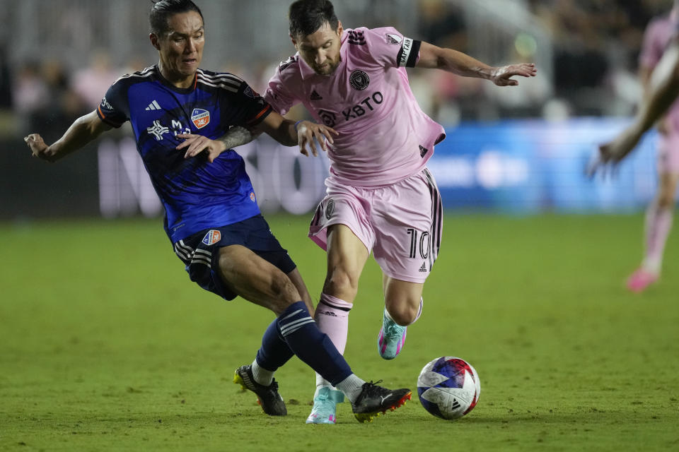 FC Cincinnati forward Yuya Kubo, left, vies for the ball with Inter Miami forward Lionel Messi (10) ball during the second half of an MLS soccer match, Saturday, Oct. 7, 2023, in Fort Lauderdale, Fla. (AP Photo/Rebecca Blackwell)