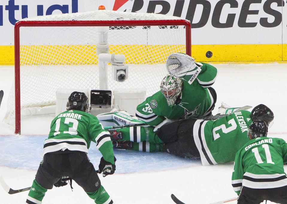 Dallas Stars goalie Anton Khudobin (35) makes a save against the Vegas Golden Knights as Stars defenseman Jamie Oleksiak (2) slides into the crease during second-period NHL Western Conference final playoff game action in Edmonton, Alberta, Saturday, Sept. 12, 2020. (Jason Franson/The Canadian Press via AP)