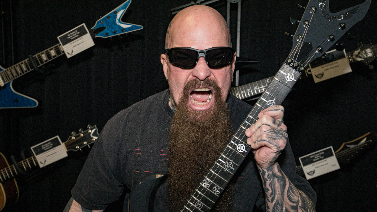  Kerry King holding a guitar and shouting. 