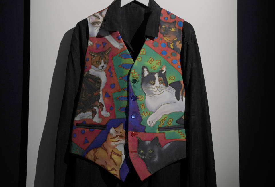 Freddie Mercury's silk waistcoat featuring portraits of Freddie Mercury's six cats, painted by Nerissa Ratcliffe, displayed at Sotheby's auction rooms in London, Thursday, Aug. 3, 2023. More than 1,000 of Freddie Mercury's personal items, including his flamboyant stage costumes, handwritten drafts of "Bohemian Rhapsody" and the baby grand piano he used to compose Queen's greatest hits, are going on show in an exhibition at Sotheby's London ahead of their sale. (AP Photo/Kirsty Wigglesworth)
