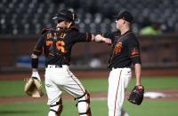 <p>Rob Brantly #76 elbow bumps Sam Wolff #83 of the San Francisco Giants after they beat the Oakland Athletics in their exhibition game at Oracle Park on July 21 in San Francisco.</p>