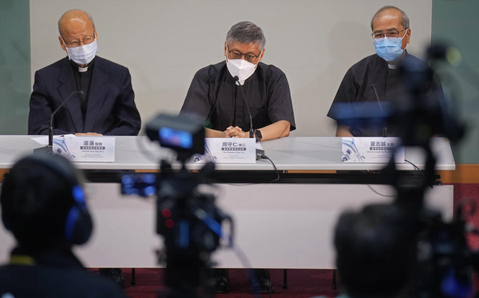 From left, Cardinal John Tong Hon, Stephen Chow Sau-yan, and Bishop Joseph Ha Chi-Shing, OFM Auxiliary Bishop of Hong Kong, attend a press conference in Hong Kong Tuesday, May 18, 2021. Pope Francis on Monday named a new bishop for Hong Kong, tapping the head of his own Jesuit order in the region, the Rev. P. Stephen Chow Sau-Yan, for the politically sensitive position that has been vacant for two years. (AP Photo/Vincent Yu)