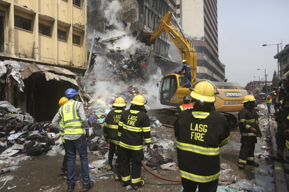 A crane operator works at the site of a fire in Balogun Market in downtown Lagos, Nigeria, Nov. 6, 2019. (Photo: Sunday Alamba/AP)