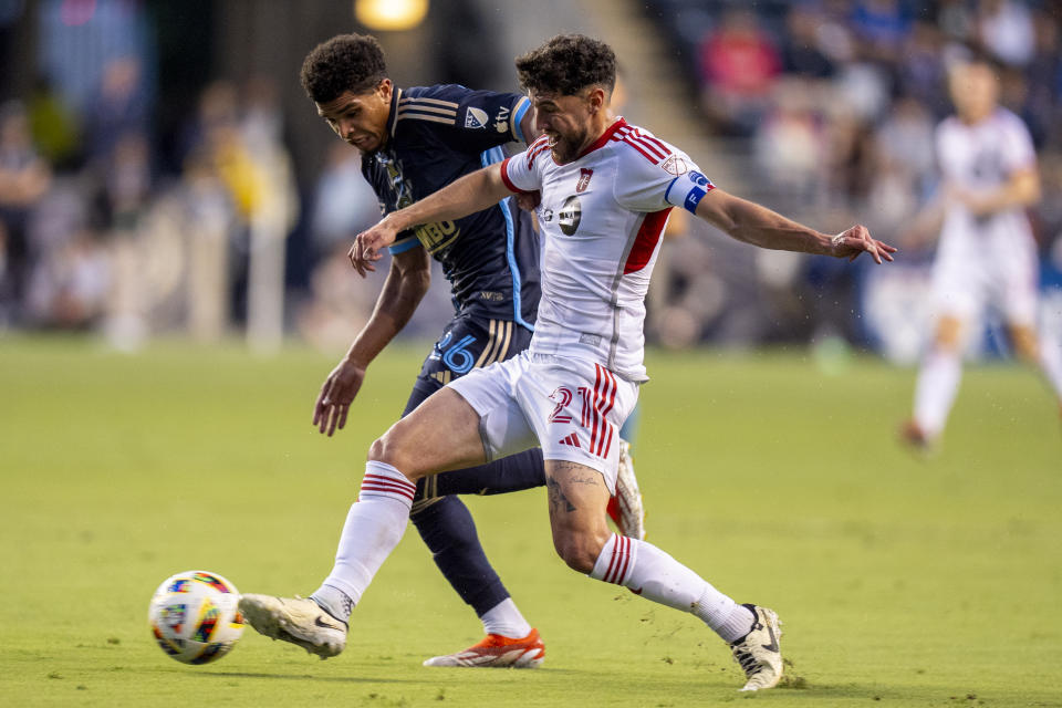 Toronto FC's Jonathan Osorio, left, and Philadelphia Union's Nathan Harriel vie for the ball during the first half of an MLS soccer match Wednesday, May 29, 2024, in Chester, Pa. (AP Photo/Chris Szagola)