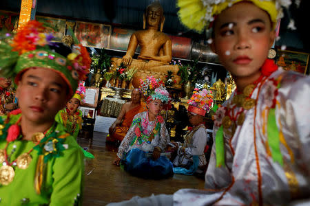 Boys stay inside a temple during an annual Poy Sang Long procession, part of the traditional rite of passage for boys to be initiated as Buddhist novices, in Mae Hong Son, Thailand, April 3, 2018. REUTERS/Jorge Silva