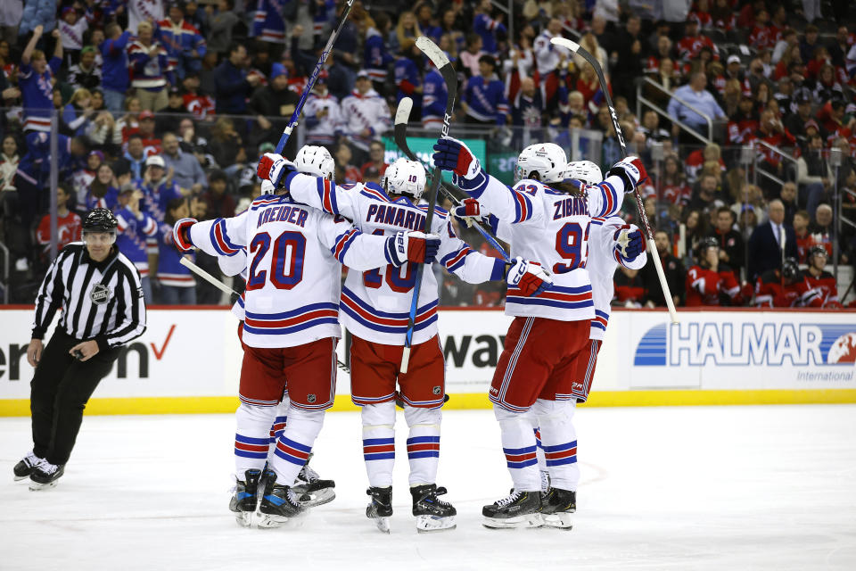 New York Rangers left wing Artemi Panarin (10) celebrates with teammates after scoring a goal against the New Jersey Devils during the first period of an NHL hockey game Saturday, Nov. 18, 2023, in Newark, N.J. (AP Photo/Noah K. Murray)