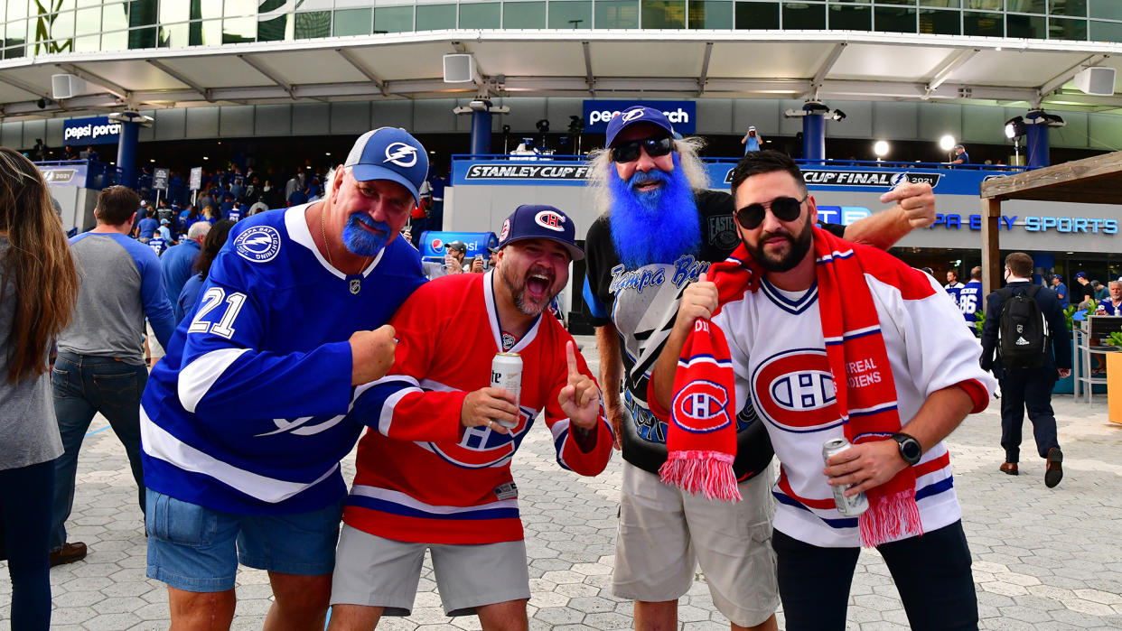 TAMPA, FLORIDA - JUNE 28:  Fans pose for a photo prior to Game One of the 2021 NHL Stanley Cup Final between the Tampa Bay Lightning and the Montreal Canadiens at Amalie Arena. (Photo by Julio Aguilar/Getty Images)