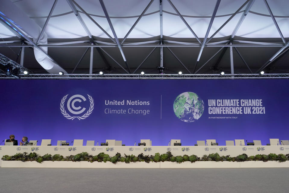 People prepare for the Procedural Opening of the COP26 U.N. Climate Summit in Glasgow, Scotland, Sunday, Oct. 31, 2021. The U.N. climate summit in Glasgow formally opens Sunday, a day before leaders from around the world gather in Scotland's biggest city to lay out their vision for addressing the common challenge of global warming. (AP Photo/Alberto Pezzali, Pool)