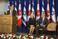 Israel's Prime Minister Benjamin Netanyahu (L) delivers a speech as his Canadian counterpart Stephen Harper (R) and his wife Laureen listen during a welcoming ceremony for Harper at Netanyahu's office in Jerusalem January 19, 2014. Harper is on a four-day visit to Israel and the Palestinian Territories. REUTERS/Baz Ratner(JERUSALEM - Tags: POLITICS)